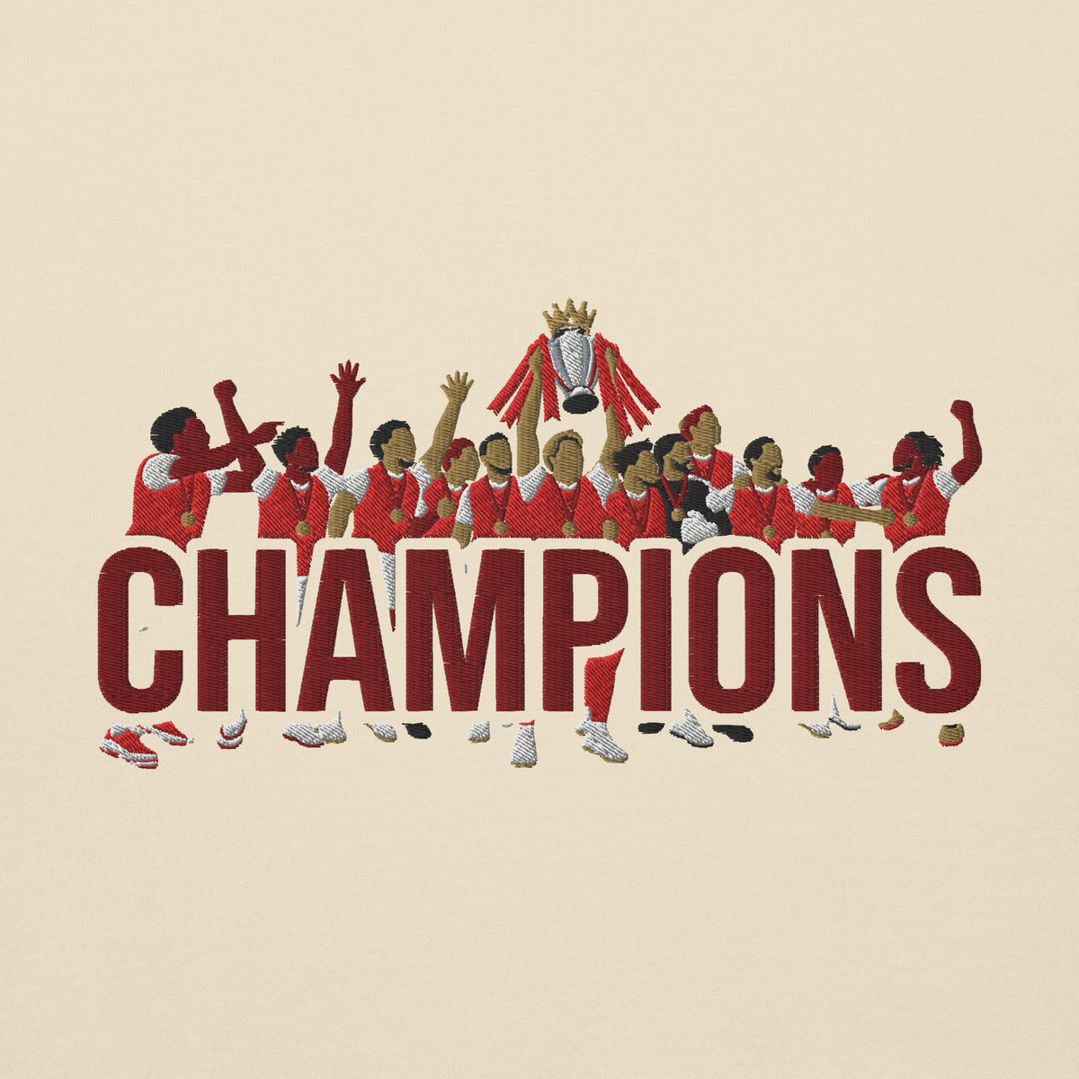Embroidery close-up of Arsenal-inspired bone sweatshirt with trophy-lift embroidery and CHAMPIONS lettering